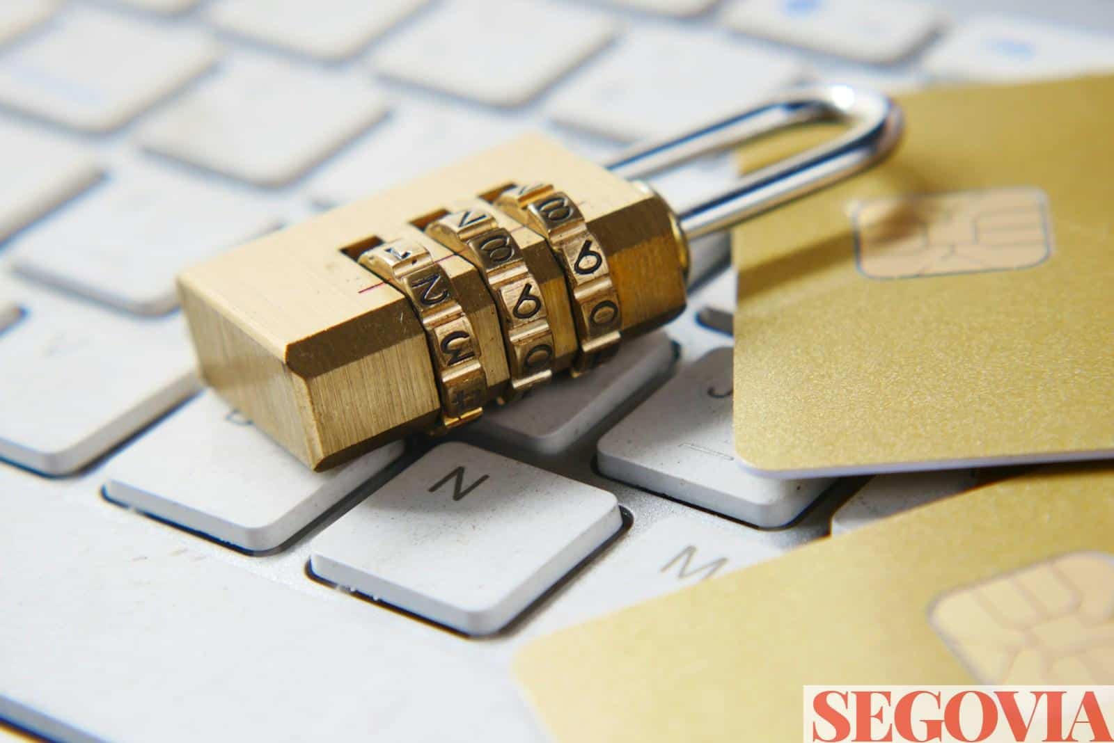 a golden padlock sitting on top of a keyboard
